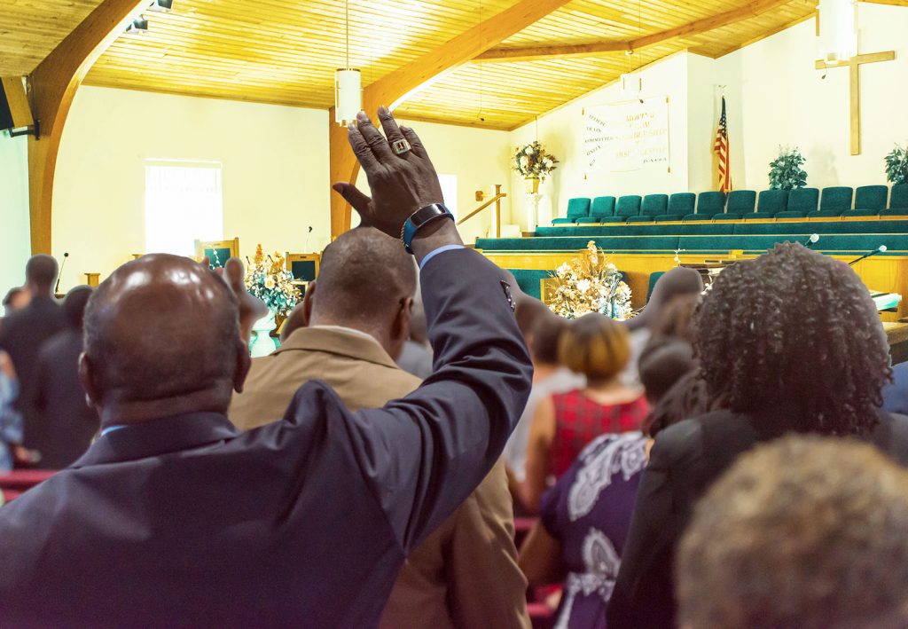 African,American,Man,At,Church,With,His,Hand,Raised